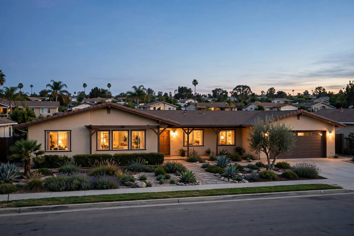 A California home at dusk with its lights on